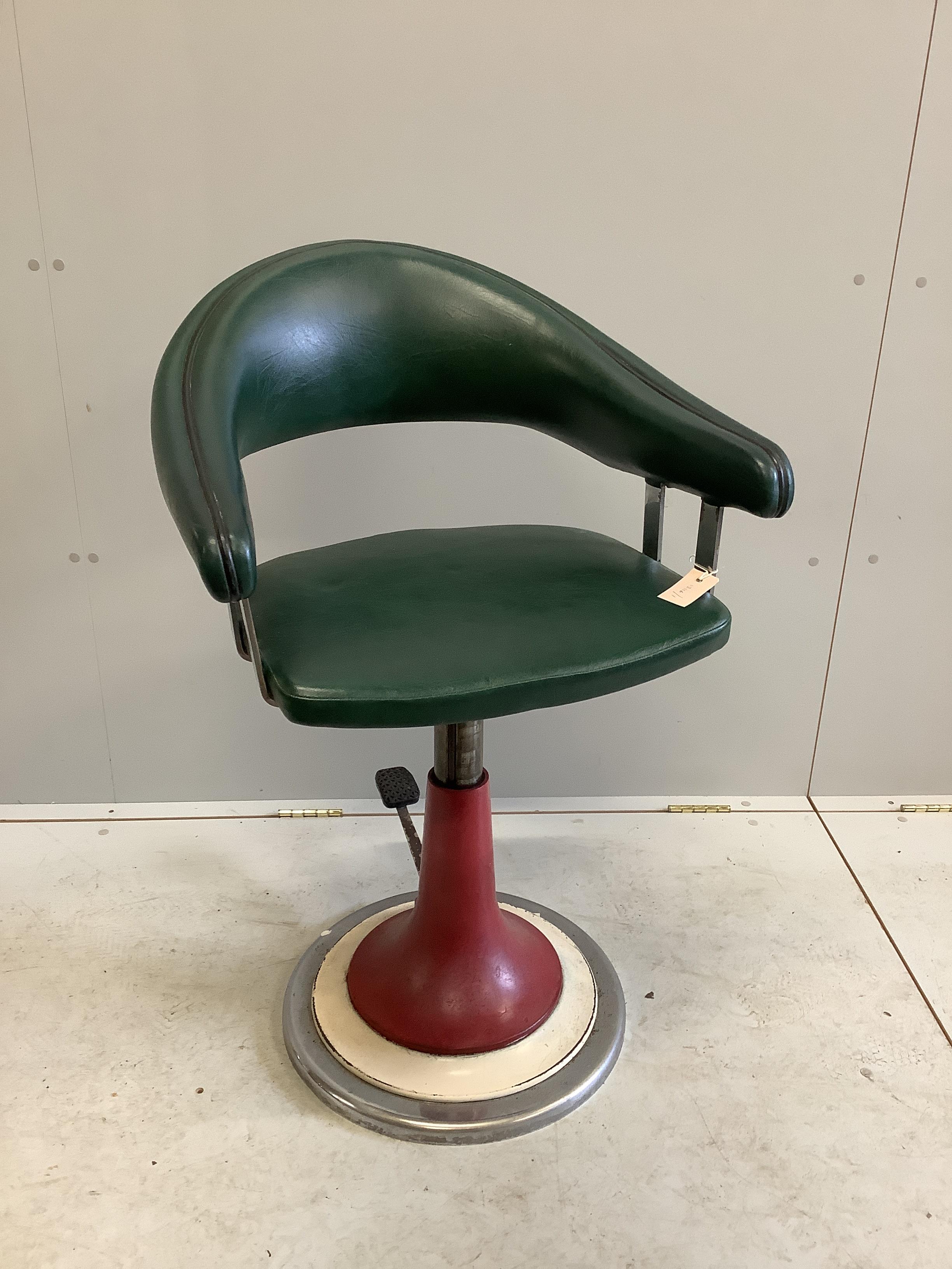 A mid century leatherette adjustable barber's chair